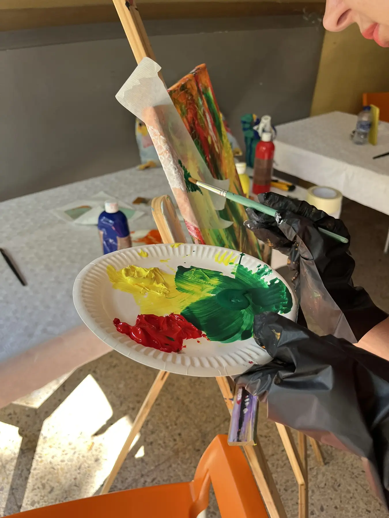 Paint and brushes prepared during an art therapy class