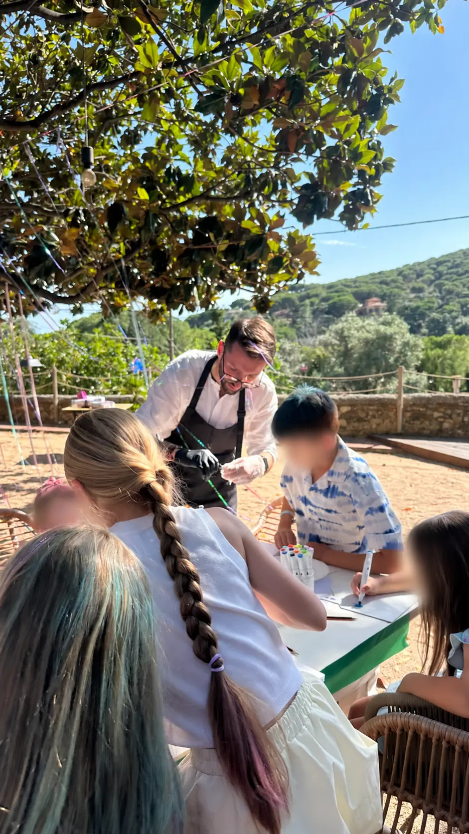 TK leading a creative workshop for children at an outdoor event