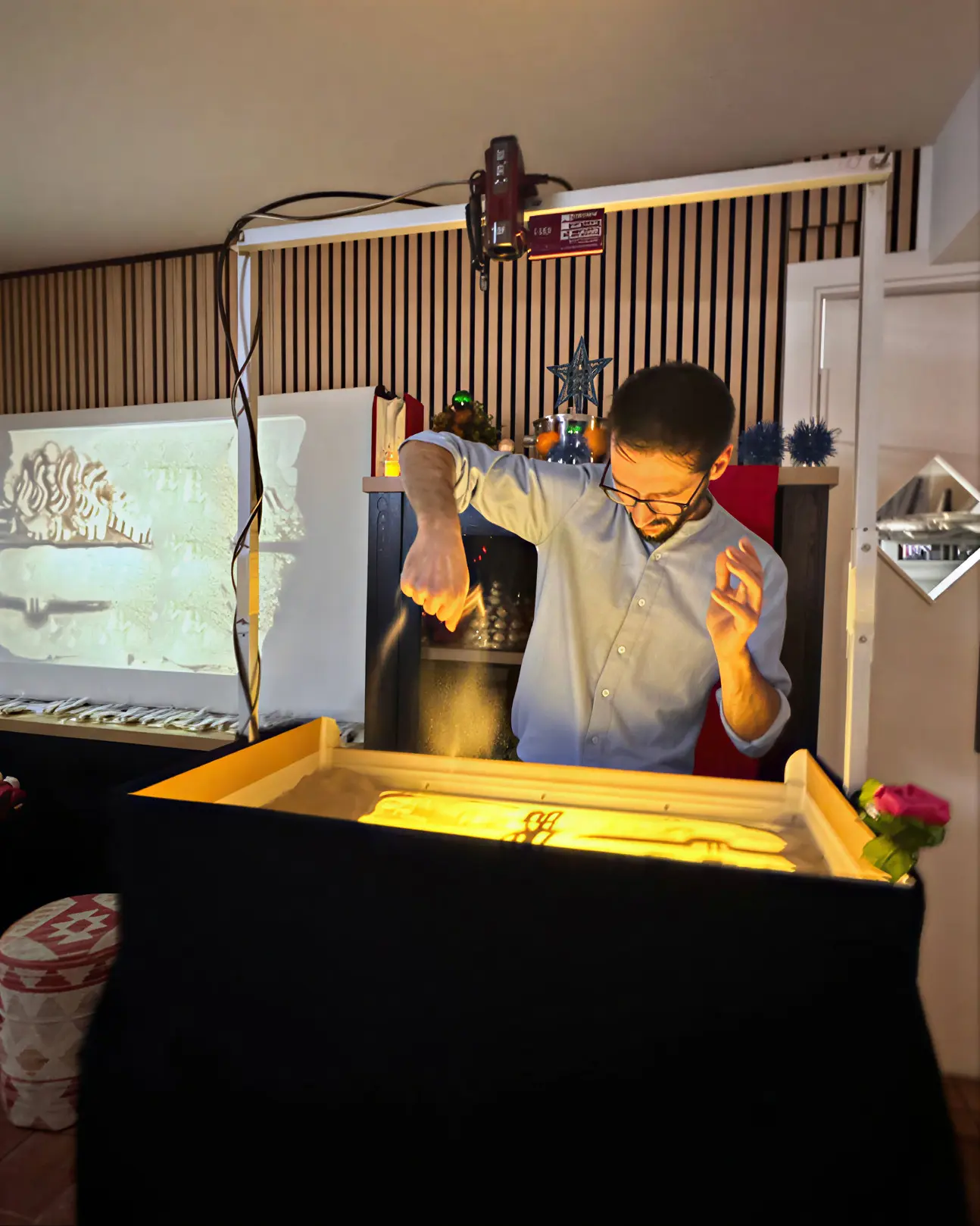 TK giving a sand-art performance at Tea Party with TK