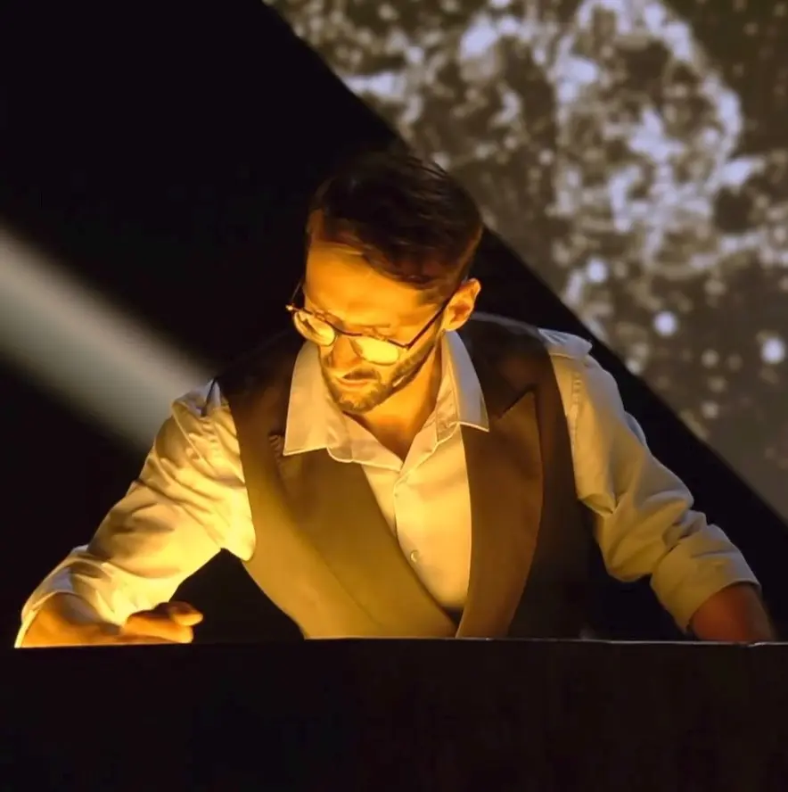 TK performing sand art on stage